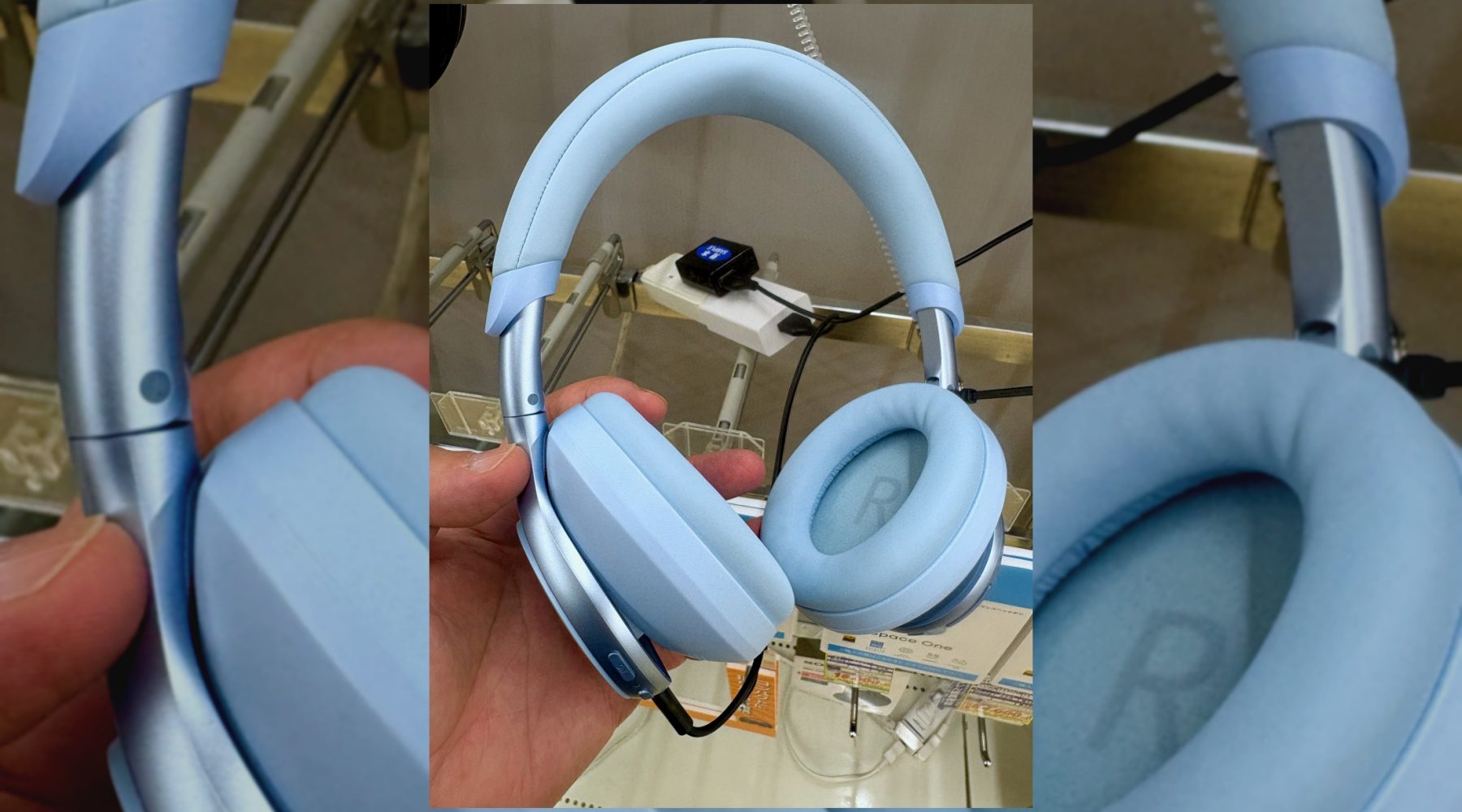 Over-ear active noise cancelling headphones being inspected by hand