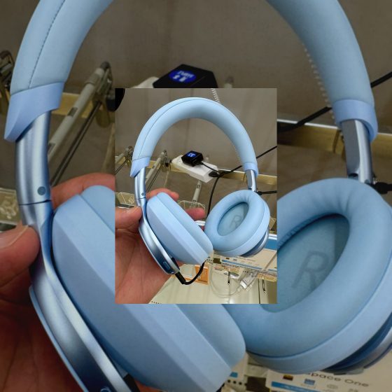 Over-ear active noise cancelling headphones being inspected by hand